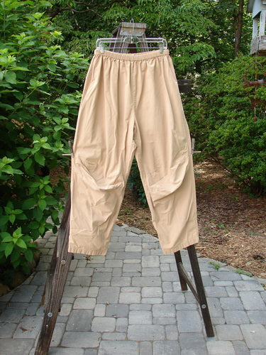 2000 Parachute Trekker Pant Unpainted Carmel Size 2 displayed on a clothes rack, highlighting the sturdy, tightly woven, medium-weight cotton fabric with additional knee fabric and a full elastic waistline.