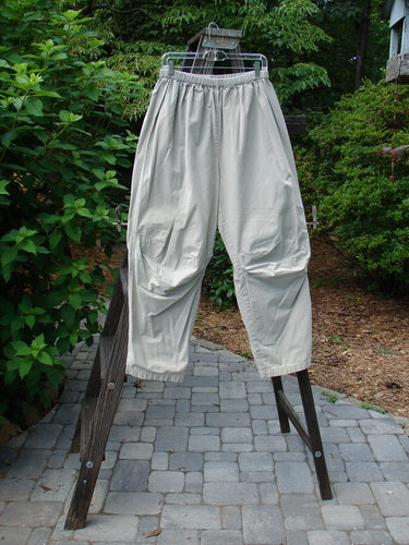 2000 Parachute Trekker Pant Unpainted Sand Size 2: A pair of white pants on a wooden bench, made from medium weight cotton parachute fabric. Features include additional knee fabric, slightly tapering lowers, and a full elastic waistline.