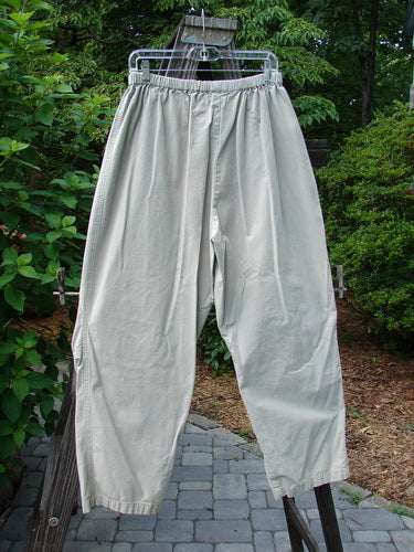 2000 Parachute Trekker Pant Unpainted Sand Size 2: Sturdy cotton pants on a clothes rack. Knee fabric detail, tapered lowers, and elastic waistline.