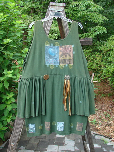 1992 Peplum Dress Sun Moon Star Evergreen OSFA, showcasing oversized buttons, a scooped neckline, and a vibrant sun and moon design. Features gathered peplum and hand-dyed silk ribbon accents, reflecting vintage charm.