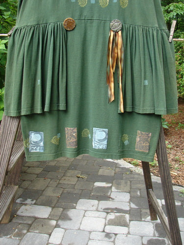Close-up of the 1992 Peplum Dress Sun Moon Star Evergreen OSFA, highlighting its oversized vintage buttons, mega gathered peplum, and hand-dyed silk ribbon accents, embodying Bluefishfinder.com's vintage aesthetic.