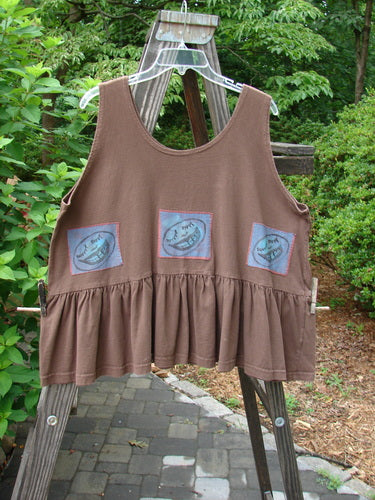 1992 Patched Peplum Top Happy Face Mushroom OSFA displayed on a wooden ladder, featuring blue designs, a flounce bottom, and a signature star patch on the back.