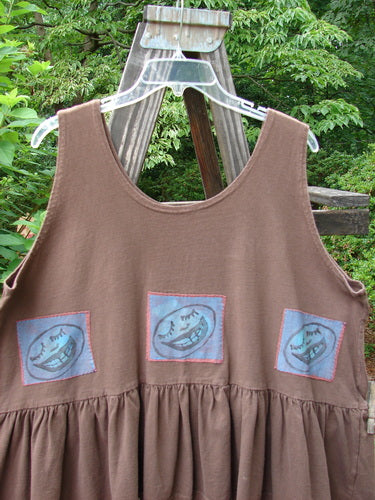 1992 Patched Peplum Top Happy Face Mushroom OSFA: This vintage top features a yoke waist seam, high arm openings, and a wide gathered flounce, adorned with a blue face patch on the back.