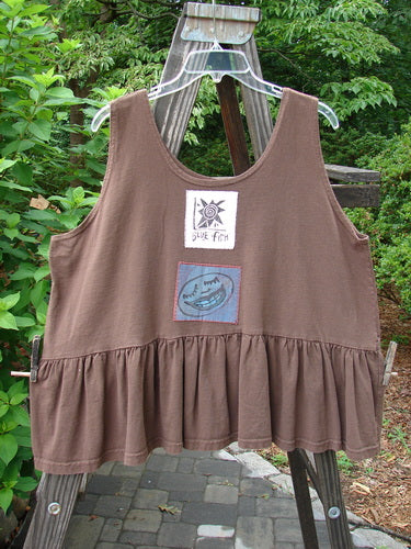 1992 Patched Peplum Top Happy Face Mushroom OSFA: A brown tank top featuring a star patch on the back, downward yoked waist seam, high arm openings, and a gathered bottom flounce with painted happy face theme.