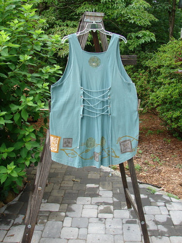 1993 Cha Cha Jumper Grey Green OSFA: A blue tank top on a rack, with a reverse triangular insert, empire waist seam, and gathered bust area.