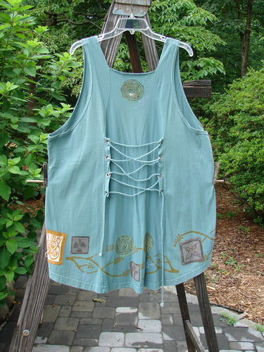 1993 Cha Cha Jumper Grey Green OSFA displayed on a wooden stand, featuring a squared neckline, A-line flare, rear metal grommets with thick cord pull, and branch and swirl block prints.