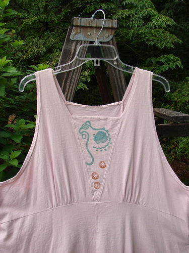 1993 Cha Cha Jumper Seashell Ash Pink OSFA displayed on a swing, showcasing its squared neckline, empire waist seam, and seashell-themed block prints.