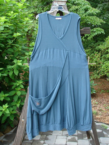 Barclay Patched Thermal Traverse Jumper in Teal Size 2 hanging on a clothesline, showcasing unique textures, sectional accents, and a floppy pocket against an outdoor backdrop.