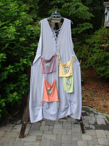 1997 Salt Water Taffy Jumper Rain Size 2 displayed on a rack, featuring rippie accents, tie-on pockets, bodice buttons, hem loops, and ocean coral-themed paint, exemplifying BlueFishFinder's vintage style.