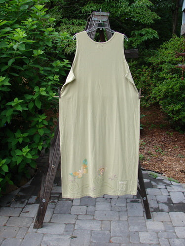 1999 River Journey Dress Butterfly Kelp Size 2 on a clothes rack, showcasing a scoop rounded neckline, slimmer shape, deeper arm openings, and vibrant butterfly theme paint, highlighted by the Blue Fish patch.