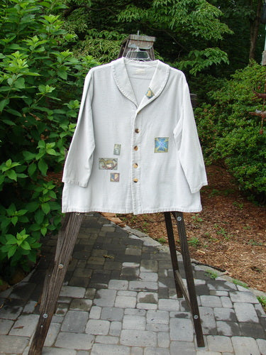 1999 Patched Flannel PJ Top Blue Horizon Size 0 displayed on a stand, showcasing drop shoulders, vented sides, fold-over collar, and multiple front and rear patches.