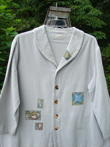 1999 Patched Flannel PJ Top Blue Horizon Size 0 featuring oversized fit, drop shoulders, vented sides, fold-over collar, front and back patches, rounded side buttons, and rollable sleeves, made from thick cozy flannel.