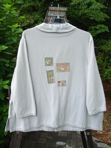 1999 Patched Flannel PJ Top Blue Horizon Size 0 featuring four rear and five front patches, drop shoulders, vented sides, fold-over collar, rounded buttons, and rollable sleeves.