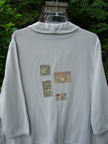 1999 Patched Flannel PJ Top Blue Horizon Size 0, featuring drop shoulders, vented sides, a fold-over collar, multiple patches, rounded side buttons, and rollable sleeves, displayed in a cozy, oversized fit.