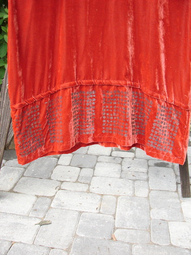 2000 NWT Silk Velvet Templeisen Gown Starlight Sienna Size 1 displayed on a chair, showcasing its flowing silk velvet fabric, unique snap-off hemline, V-shaped neckline, and belled sleeves.