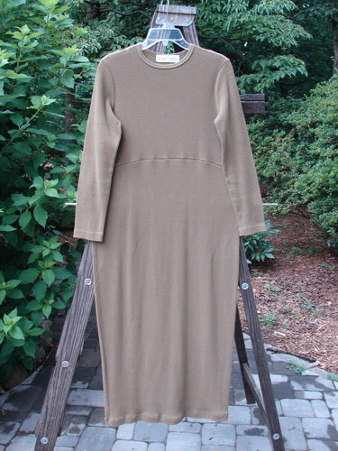 1998 Pebble Dress Unpainted Leaf Size 1 displayed on a wooden hanger, showcasing its long sleeves, thick ribbed texture, and pegged bottom.
