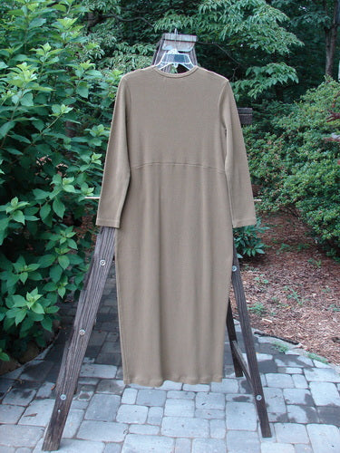 1998 Pebble Dress Unpainted Leaf Size 1 displayed on a swing, showcasing its thick, ribbed material, downward yoked waist seam, and pegged bottom, perfect for layering or standalone wear.