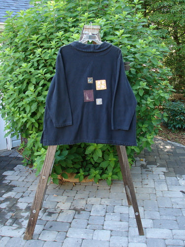 1999 Patched Flannel PJ Top Paper Doll Black Size 1 displayed on a hanger, showcasing thick fabric, drop shoulders, vented sides, fold-over collar, and playful patches.