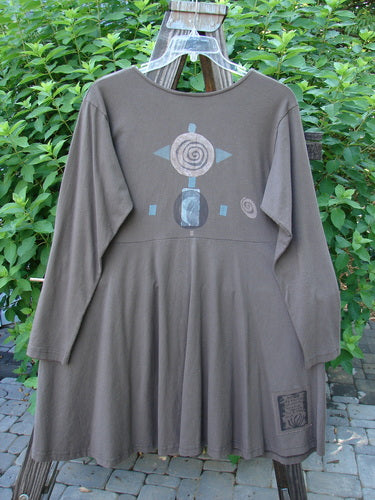 1994 Poppy Dress Collarless Figure Eight Woman Humus Size 2 on a clothes rack, featuring a rolled collar, vintage buttons, empire waistline, and a full sweeping lower with a painted figure-eight design.