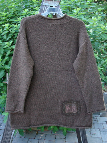 1998 Alpaca Patched Simple Tunic Sweater in Mixed Forest Tweed, featuring a ribbed mock collar, dropped shoulders, triple nature-themed patches, and Blue Fish signature patch, displayed on a hanger.
