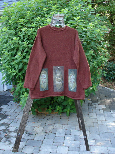 1998 Alpaca Patched Simple Tunic Sweater Autumn Fall Sprig Tweed OSFA displayed on a wooden swing, highlighting its rolled collar, ribbed patterns, oversized nature-themed patches, and varying hemline.