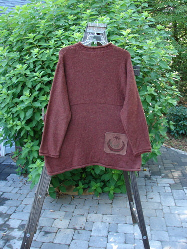 1998 Alpaca Patched Simple Tunic Sweater Autumn Fall Sprig Tweed OSFA hanging on a rack outdoors, showcasing its intricate textures, rolled mock collar, and oversized nature-themed patches.