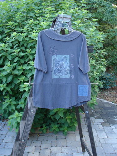 1994 Cross Collar Top Garden Bugs Blue Coal Size 1 displayed on a rack, featuring a pointed sailor collar and Blue Fish buttons, with a bee graphic and cross-stitch accents.