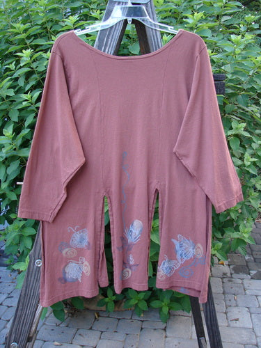 1994 Windmill Top Butterfly Clay Size 1: A long-sleeved pink shirt with a free-flowing six-panel lower, wider neckline, and repetitive butterfly design, highlighting vintage Blue Fish Clothing's creative expression.