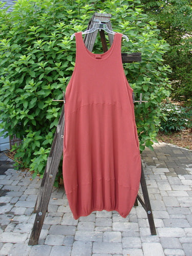 Barclay Thermal Teapot Jumper Unpainted Pomme Size 1 displayed on a wooden rack, showcasing its ribbed thermal waffle fabric, deep side pockets, and unique belled hemline, perfect for cozy fall wear.