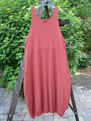 Barclay Thermal Teapot Jumper Unpainted Pomme Size 1 displayed on a wooden rack, showcasing its cozy ribbed thermal waffle fabric and unique bell-shaped hemline.