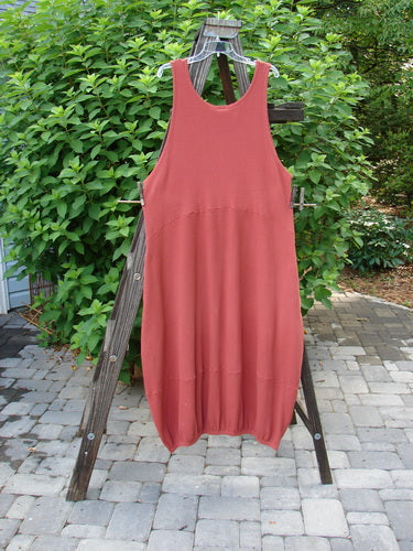 Barclay Thermal Teapot Jumper Unpainted Pomme Size 1 draped on a wooden ladder, showcasing its cozy ribbed thermal waffle fabric and deep side pockets.