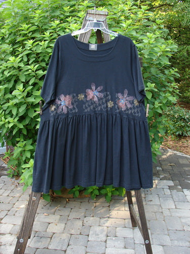 2000 Rosalee Dress Continuous Floral Black Size 2, displayed on a swing, showcasing a swingy babydoll style with a gathered waistline and floral theme bodice.