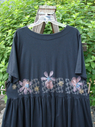2000 Rosalee Dress Continuous Floral Black Size 2 featuring a swingy babydoll style, gathered waistline, scooped neckline, and generous floral pattern on the bodice, made from organic cotton.