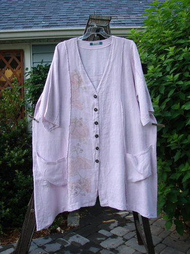 Barclay Linen Double Tie Back Jacket Wind Branch Pink Cloud Size 2 displayed on a hanger, showcasing its deep V neckline, A-line sweep, vertical stitching, and front drop-flop pockets.
