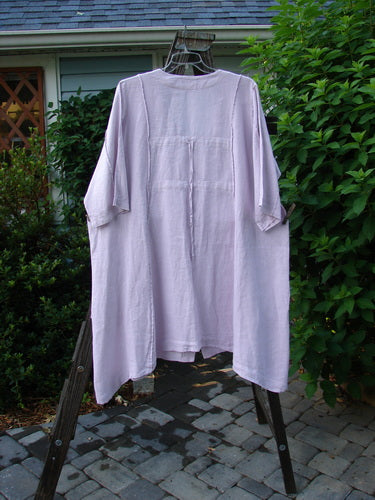Barclay Linen Double Tie Back Jacket Wind Branch Pink Cloud Size 2 on a hanger, showcasing deep V neckline, A-line sweep, vertical stitchery, front drop pockets, and varying hemline.