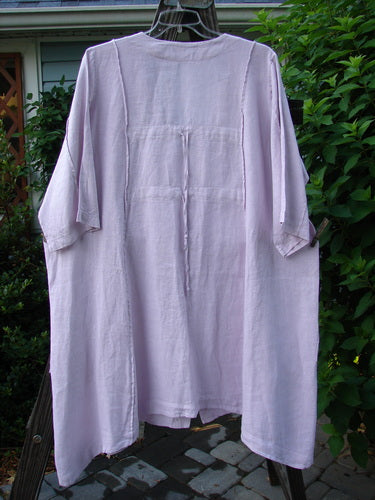 Barclay Linen Double Tie Back Jacket Wind Branch Pink Cloud Size 2, displayed on a clothesline, showcasing the deep V neckline, A-line sweep, and front drop flop pockets.