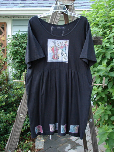1992 Patched Little Storma Dress Music Black Small OSFA with a guitar and flower drawing, deep rounded neckline, tapered lower, gathered top rear, and music-themed patches.