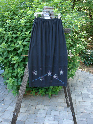 1997 NWT Indra Skirt Abstract Floral Obsidian Size 1 displayed on a rack, featuring a full elastic waistline, double paneled lower, colorful chiseled buttons, and abstract floral design.