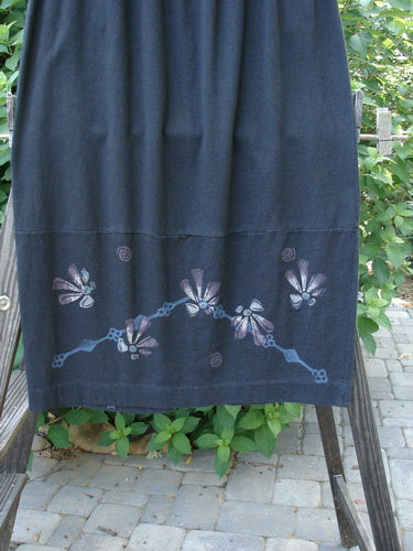 1997 NWT Indra Skirt Abstract Floral Obsidian Size 1, featuring a blue skirt with painted flowers, a full elastic waistline, double-paneled lower, mix-matched buttons, and accented vents with loop closures.