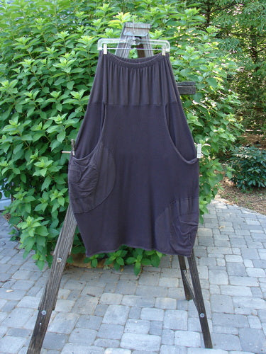 Barclay Thermal Celtic Moss Panel Pocket Circle Skirt Unpainted Darker Bark Size 2 displayed on a wooden stand, showcasing its full elastic waistline and deep front entry banded upper pockets.