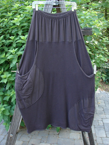 Barclay Thermal Celtic Moss Panel Pocket Circle Skirt Unpainted Darker Bark Size 2 hanging on a clothesline, featuring deep front pockets and a full elastic waistline.