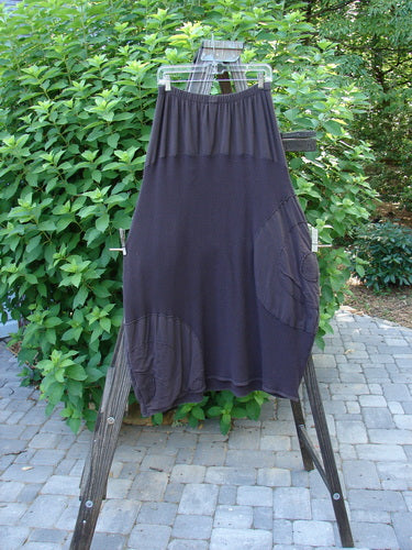 Barclay Thermal Celtic Moss Panel Pocket Circle Skirt Unpainted Darker Bark Size 2 displayed on a clothes rack, showcasing its full elastic waistline, deep front pockets, and bell-shaped hem taper.