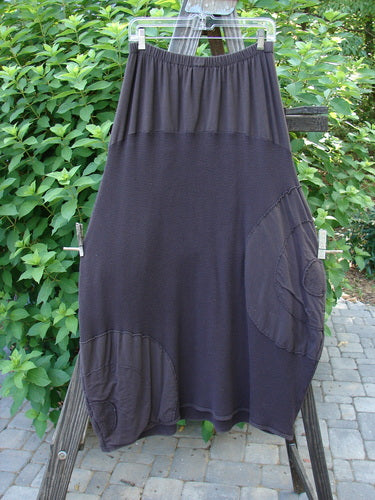 Barclay Thermal Celtic Moss Panel Pocket Circle Skirt Unpainted Darker Bark Size 2 displayed draped on a fence, showcasing its full elastic waistline, deep front pockets, and heavy-weight cotton thermal material.