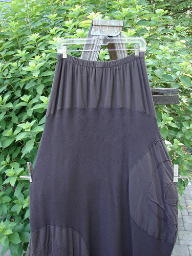 Barclay Thermal Celtic Moss Panel Pocket Circle Skirt Unpainted Darker Bark Size 2 hanging on a clothes rack, showcasing its full elastic waistline and deep front entry banded pockets.