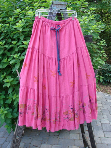 Barclay Linen Drawstring Ruffle Skirt Daisy Fence Flamingo Size 2 on a rack showcasing its ruffled design, full drawstring waistline, and sweet fringe edges.