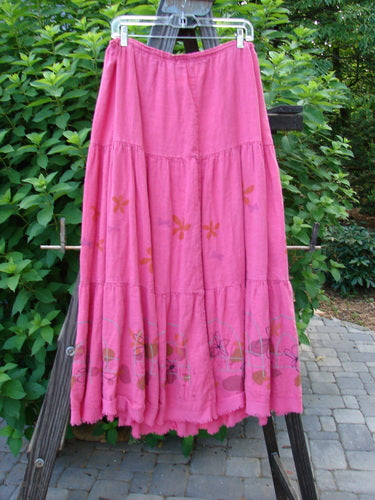 Barclay Linen Drawstring Ruffle Skirt Daisy Fence Flamingo Size 2: A pink skirt with a flower design on a rack, perfect for a summer collection.