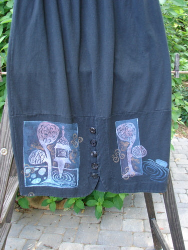1997 Indra Skirt Whimsical Forest Obsidian Size 1 featuring a whimsical forest-themed design, colorful buttons, deep side pockets, and sweet loop closures, crafted from mid-weight organic cotton with a full elastic waistline.