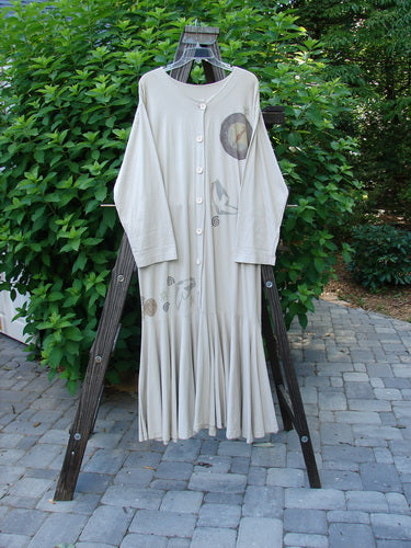 1994 Column Dress Belief Mist Size 1: A long white dress with button-down front, V-neckline, longer sleeves, and flounce hem, displayed on a rack.