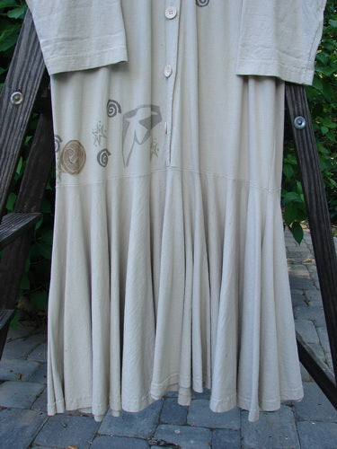 1994 Column Dress Belief Mist Size 1 displayed on a wooden ladder, showcasing its full front button duster shape, V-shaped neckline, longer sleeves, and full bottom kick flounce.