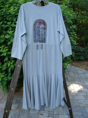 1994 Column Dress Heart Solstice Blue Size 1: A long, mid-weight cotton dress with a full front button duster shape, V-shaped neckline, longer sleeves, and abundant heart-themed paint, displayed hanging.